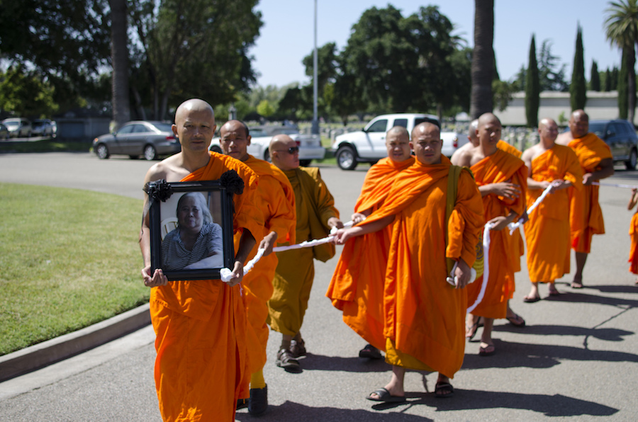 buddhist with rope marching for funeral